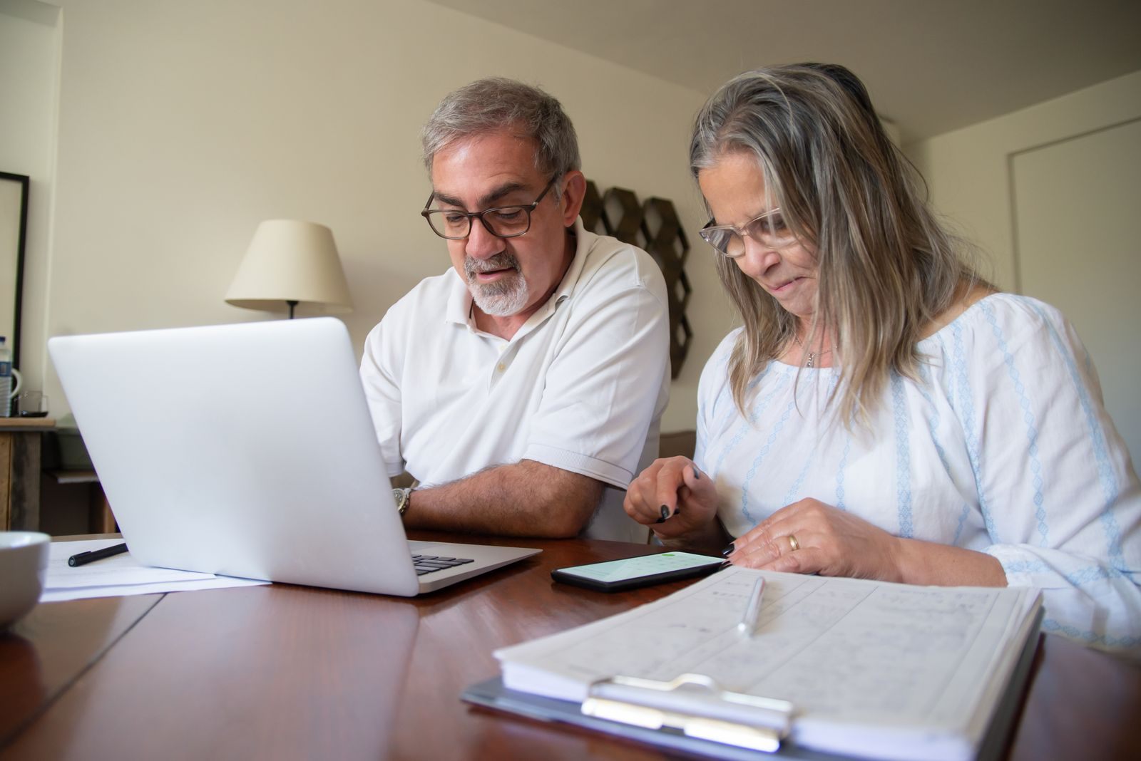 Couple reviewing documents with a laptop